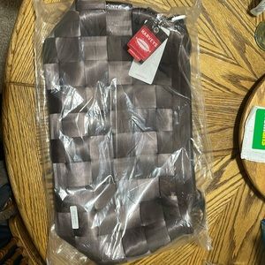 In bag never used Carry on brown seatbelt purse